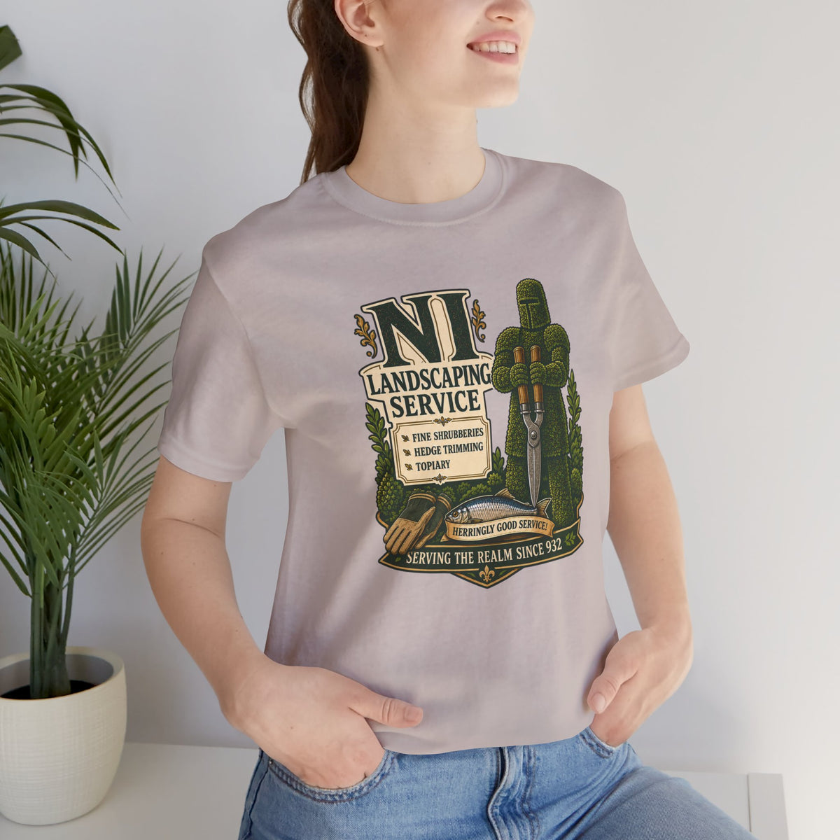 Taupe crewneck T-shirt with front NL landscaping service graphic; model wearing