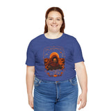 Blue crewneck t-shirt with orange illustrated hooded figure graphic on the front