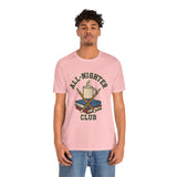 Pink crewneck T-shirt with large “All-Nighter Club” coffee-and-books graphic