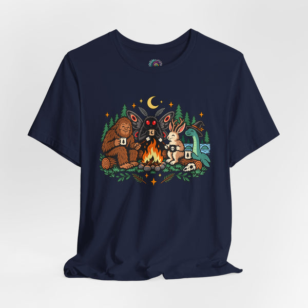 Navy crewneck t-shirt with colorful campfire cryptid graphic and starry forest accents