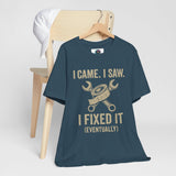 Teal T-shirt on wooden hanger with “I came, I saw, I fixed it (eventually)” tool graphic
