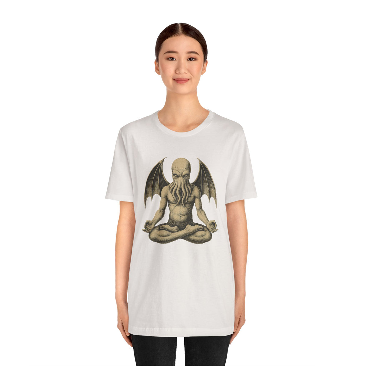 White unisex T-shirt worn by model, meditating sea monster graphic