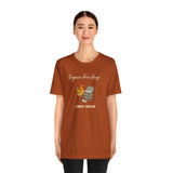 Rust orange crew-neck t-shirt worn by model; chicken and eggs graphic on chest