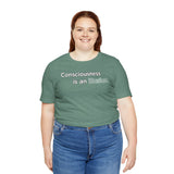 Teal crewneck T-shirt with “Consciousness is an illusion” graphic on the chest