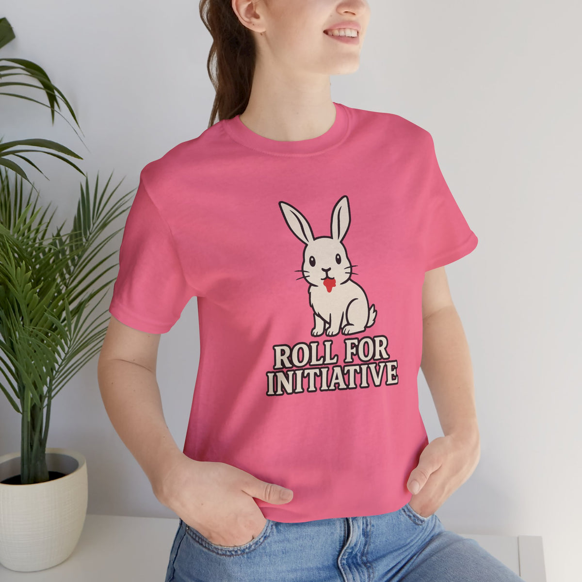 Pink crew-neck T-shirt featuring a bunny graphic and “Roll for Initiative”