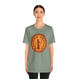 Green crewneck T-shirt with circular brown emblem graphic print on the front