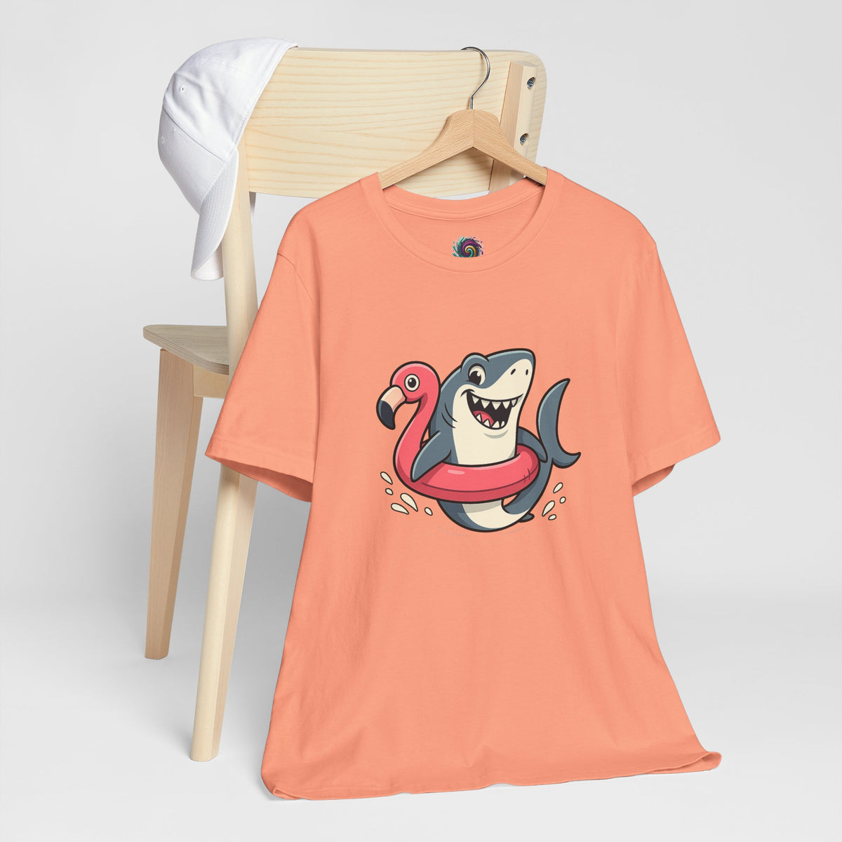 Coral short-sleeve T-shirt with shark and flamingo floatie front graphic