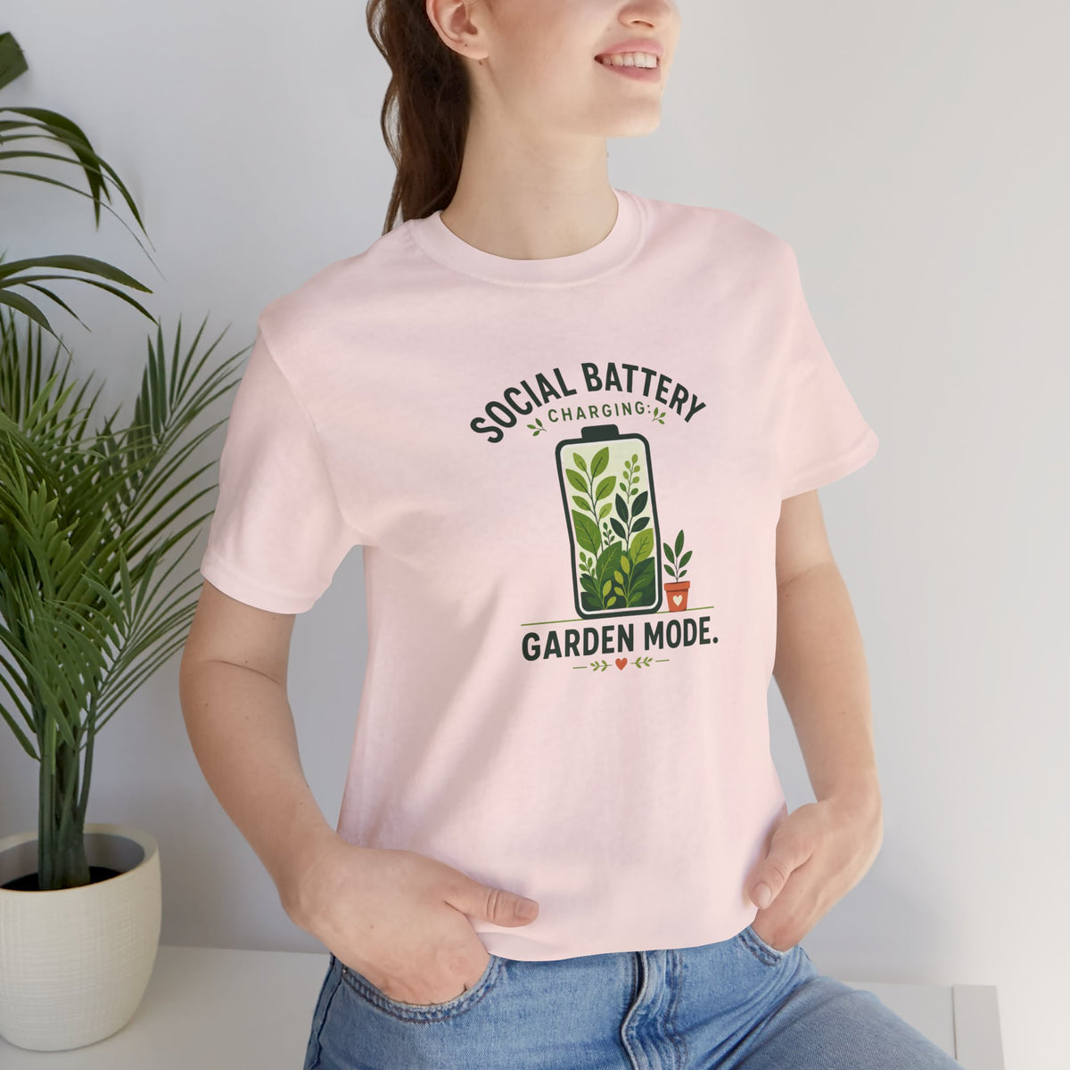 Light pink crew-neck T-shirt with “Garden Mode” garden graphic centered on chest