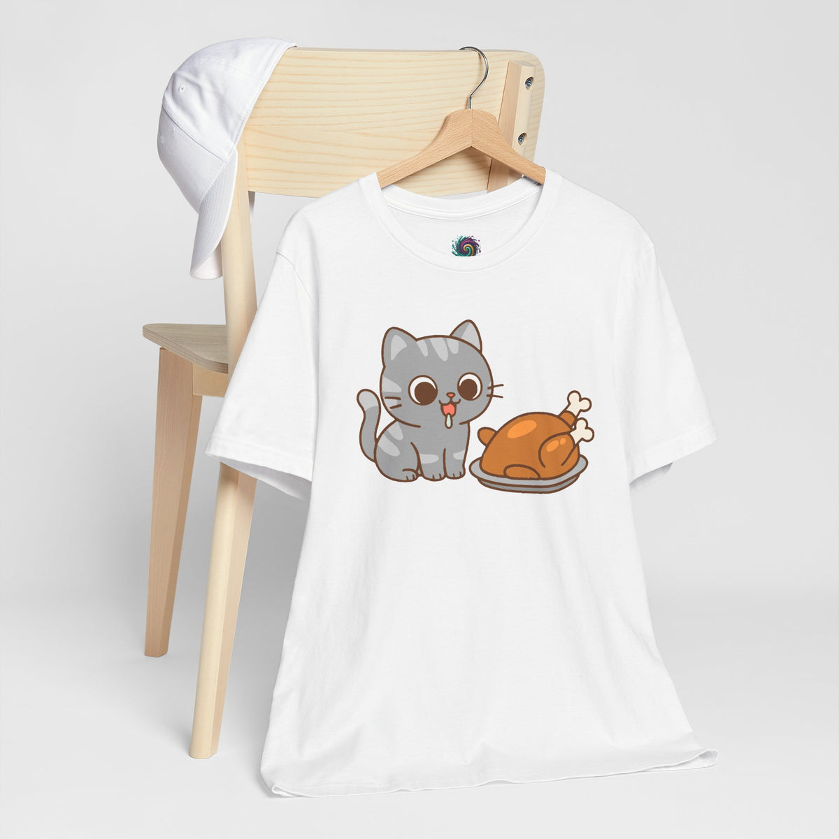 White t-shirt on hanger with cat and turkey illustration at center front