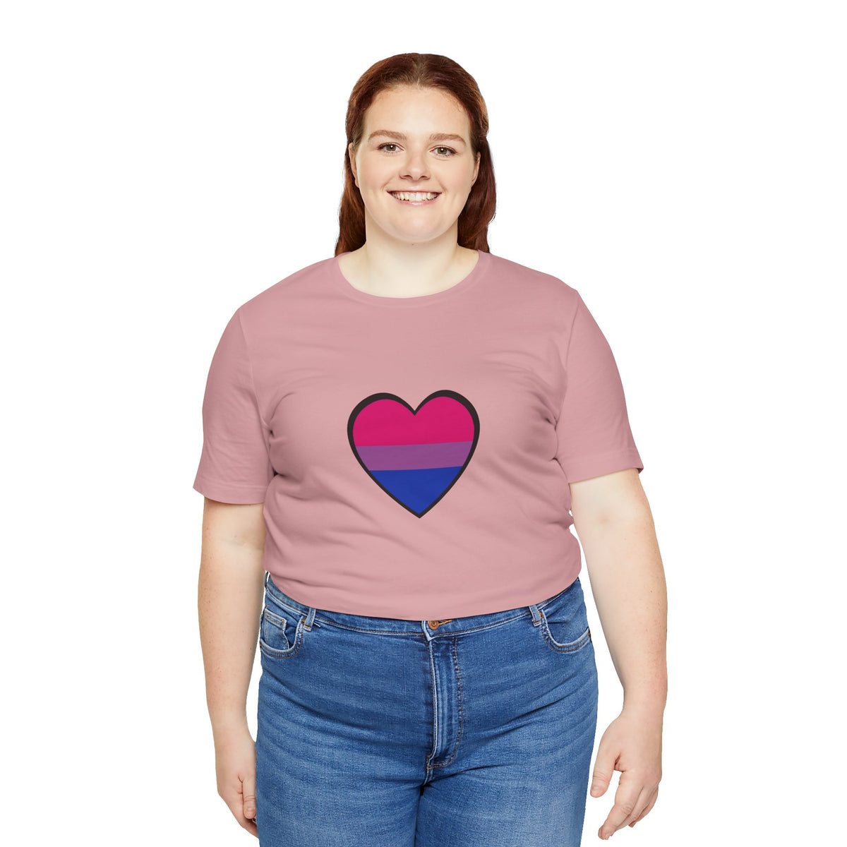 Soft pink T-shirt with outlined heart Pride flag graphic, worn with blue jeans