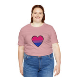 Soft pink T-shirt with outlined heart Pride flag graphic, worn with blue jeans