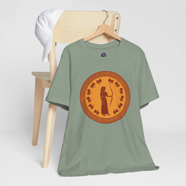 Green crewneck T-shirt with circular emblem graphic print, hanging on a wooden rack