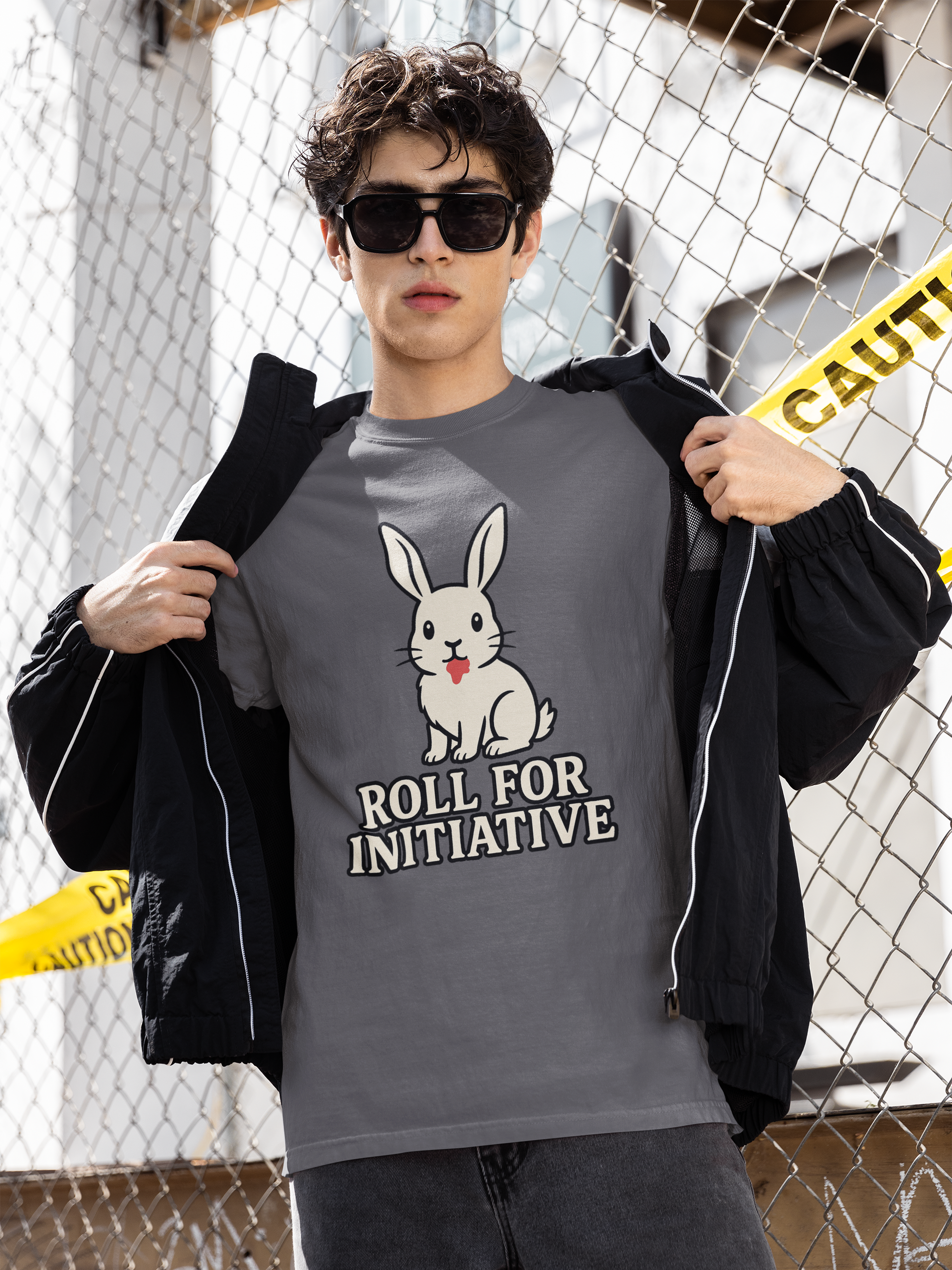 Roll for Initiative T-Shirt – Killer Bunny Humor Gaming Tee styled outdoors with a confident model and caution tape background, perfect for tabletop gamers and Monty Python fans