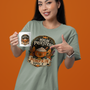 Sage green T-shirt with “High Priestess” pumpkin spice graphic on the front