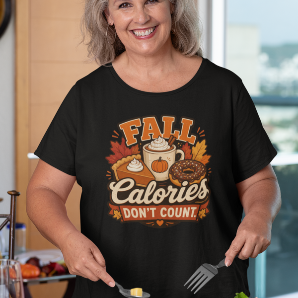 Black T-shirt with “FALL Calories Don’t Count” pumpkin graphic, worn by a woman