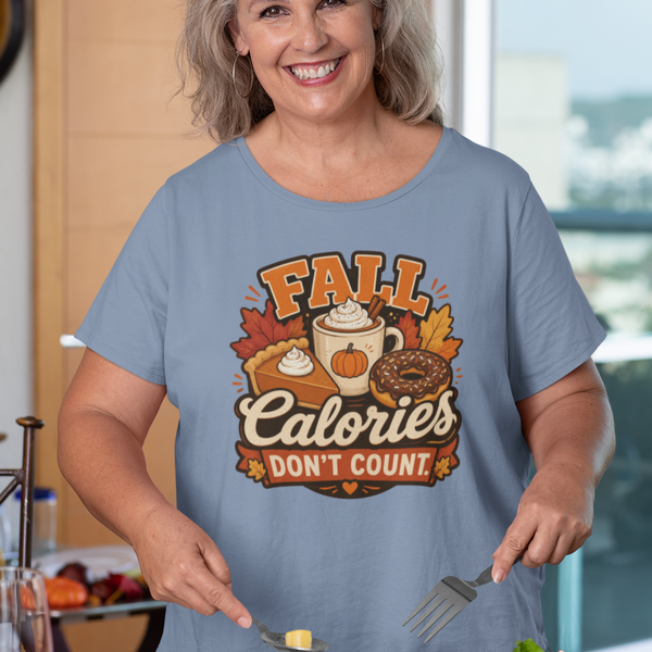 Blue T-shirt with “FALL Calories Don’t Count” pumpkin graphic, worn by a woman