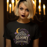 Black T-shirt with purple, gold “Gloomy is a Lifestyle Choice” graphic on front