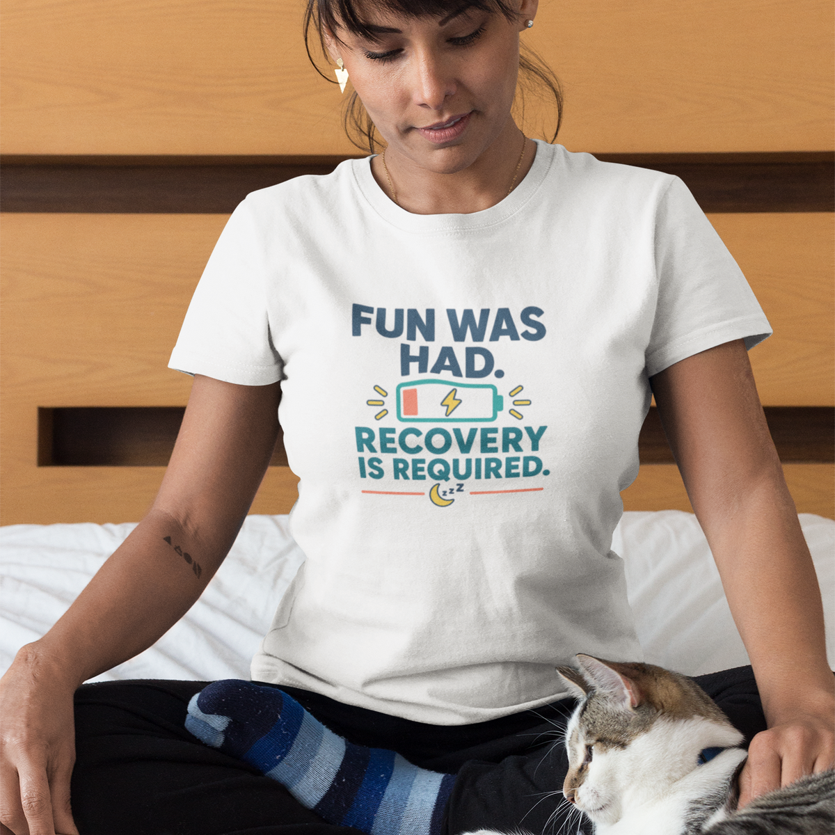 White crew-neck T-shirt with multicolor “FUN WAS HAD. RECOVERY IS REQUIRED.” graphic