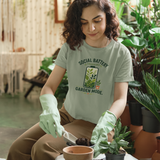 Sage green T-shirt with 'Social Battery Charging' and 'Garden Mode' plant graphic