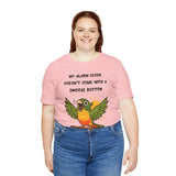 Pink parrot alarm T-shirt worn by model, with conure graphic and alarm clock wording