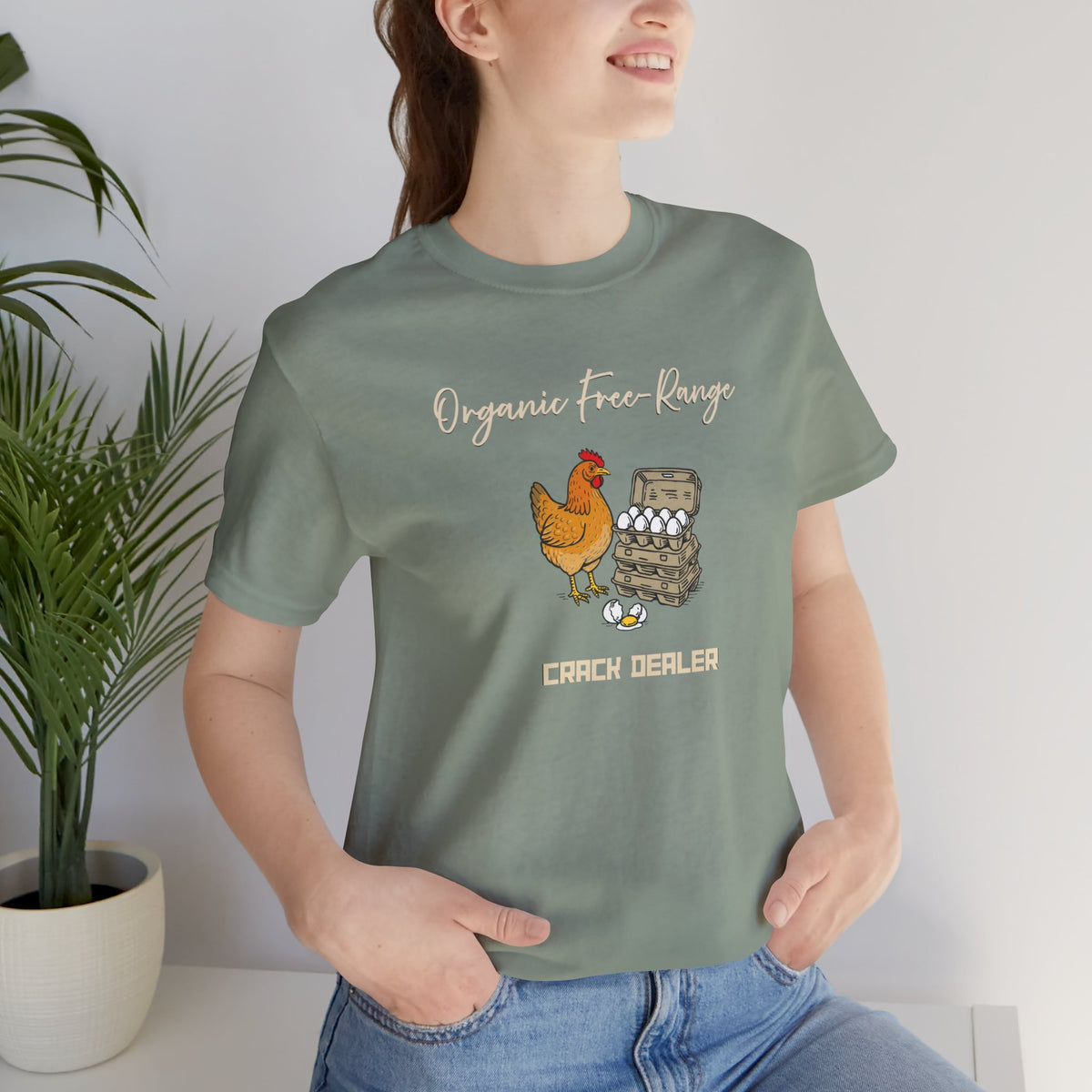 Green crew-neck graphic T-shirt close-up with “Organic free-range” and chicken-and-eggs