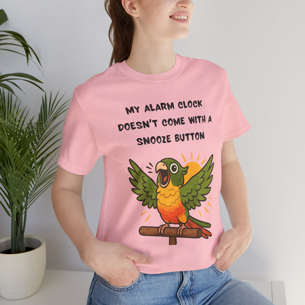 Pink parrot alarm T-shirt on model, featuring “snooze button” text and conure illustration