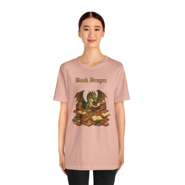 Pink crewneck t-shirt with dragon reading stacked books graphic on chest