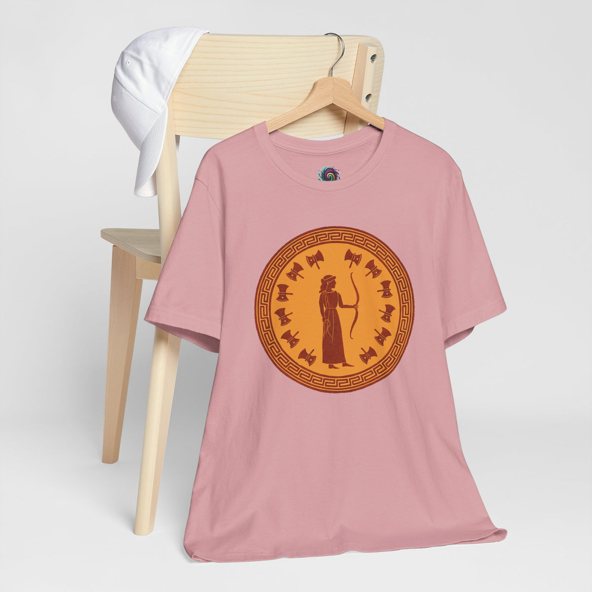 Pink t-shirt with round orange Greek goddess print at center front
