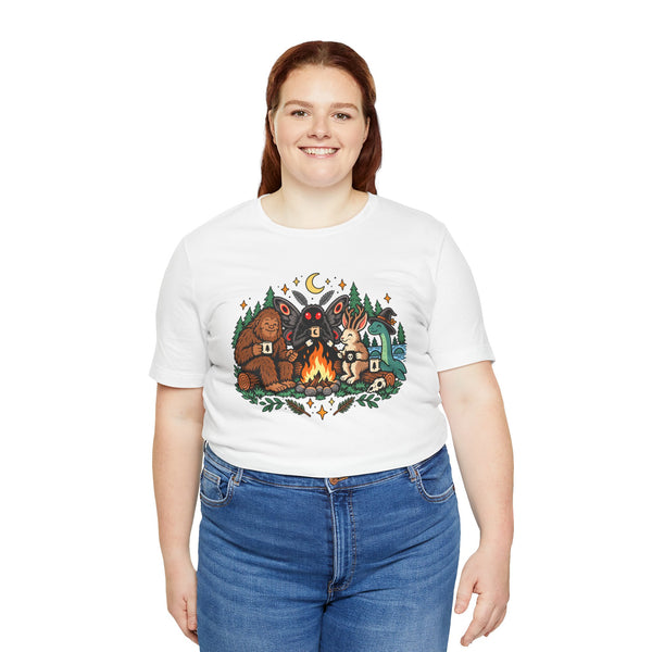White crew-neck campfire cryptid tee with colorful front graphic of three cryptid figures