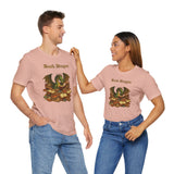 Two pink crewneck t-shirts with dragon reading stacked books graphic on front