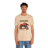 Beige crewneck T-shirt worn by model with 'PUSH-UPS' T-rex workout graphic