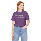 Purple crewneck graphic T-shirt with 'Consciousness is an illusion' chest text