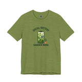 Olive green T-shirt with 'Social Battery Charging' and 'Garden Mode' plant graphic