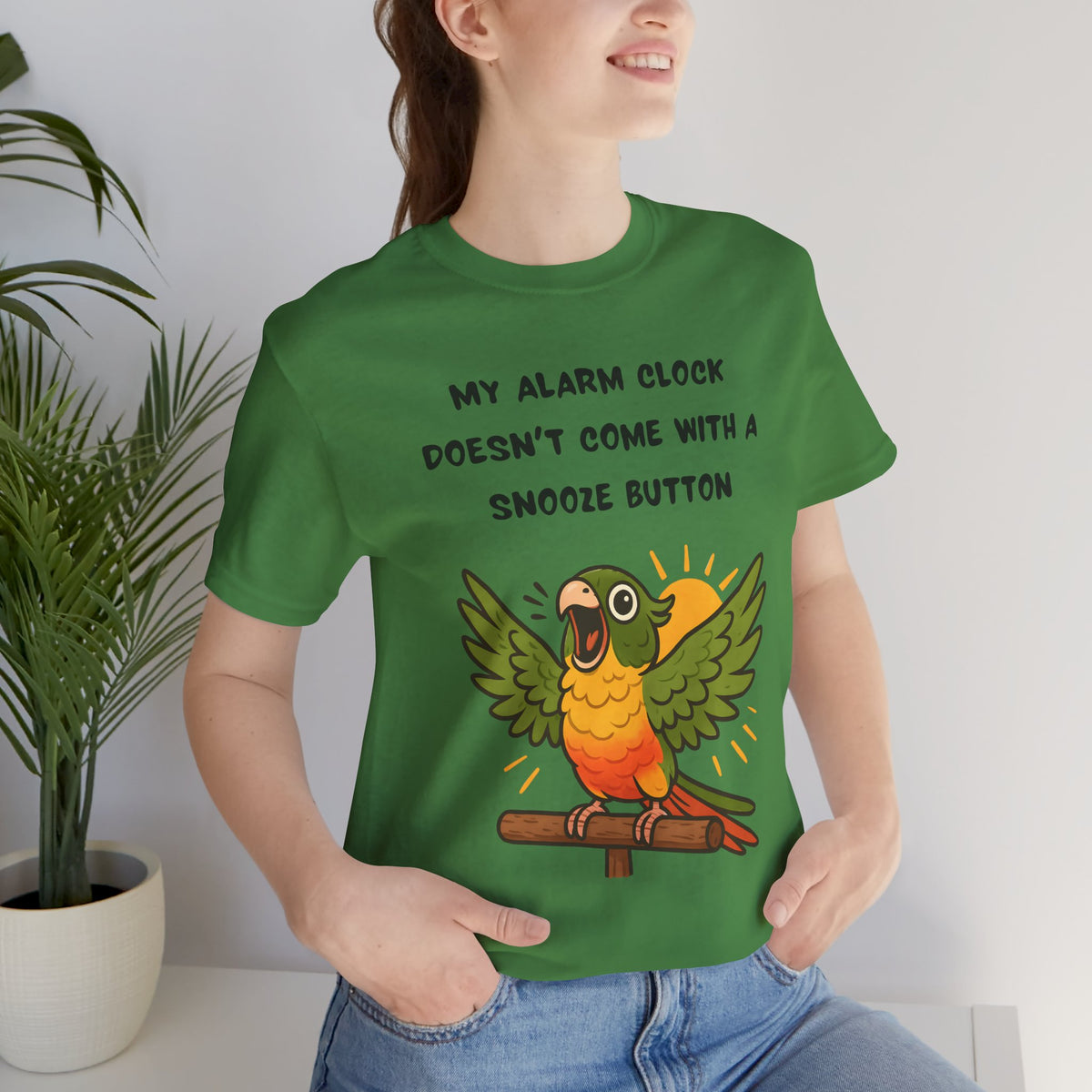 Green parrot alarm graphic T-shirt close-up with “MY ALARM CLOCK…SNOOZE BUTTON” text.
