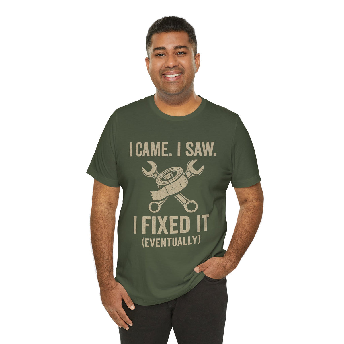 Fix-it humor T-shirt in dark green with repair tools graphic and “I fixed it (eventually)”