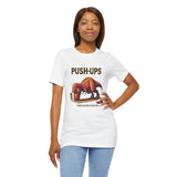 White crew-neck graphic tee with “PUSH-UPS” text and T-Rex workout illustration