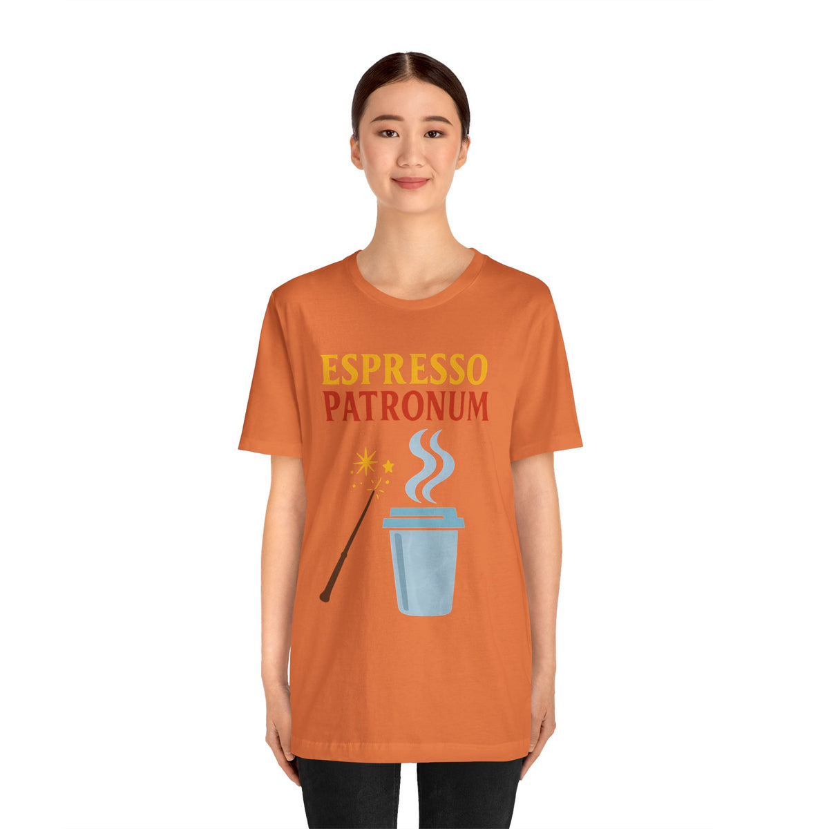 Burnt orange t-shirt on model with “Espresso Patronum” coffee cup, steam, and wand print