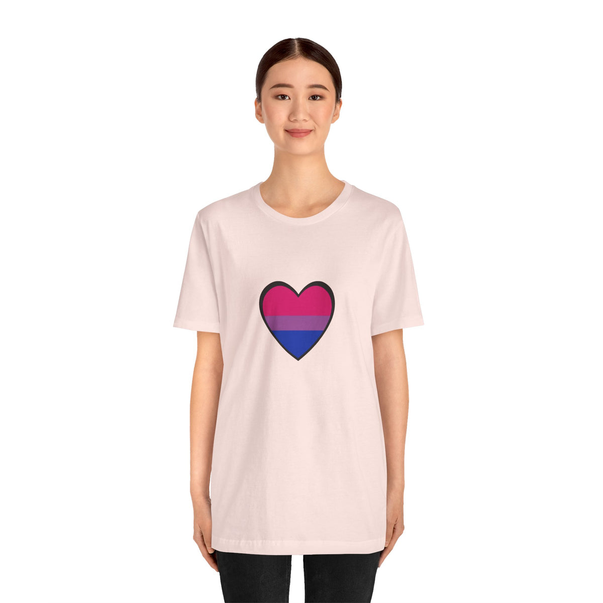 Soft pink Pride heart t-shirt with rainbow heart graphic centered on front