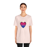 Soft pink Pride heart t-shirt with rainbow heart graphic centered on front