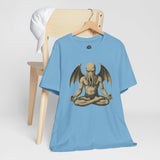 Light blue t-shirt on hanger with meditating monster graphic print on front