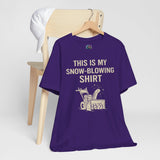 Purple graphic T-shirt on wooden hanger with snow blower illustration and winter chore slogan