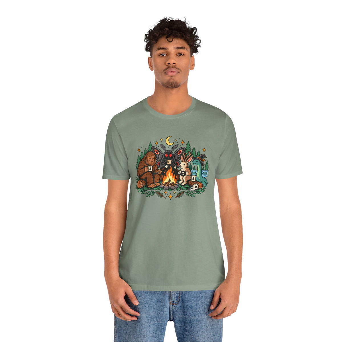 Sage green T-shirt with colorful campfire cryptid scene graphic and crew neck