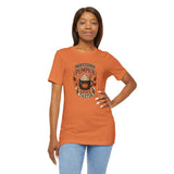 Orange crew-neck T-shirt with Pumpkin Spice Taster graphic, hand on hip