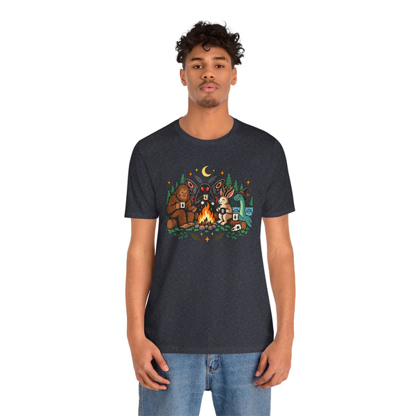 Dark crewneck t-shirt with campfire cryptid graphic and forest characters at center