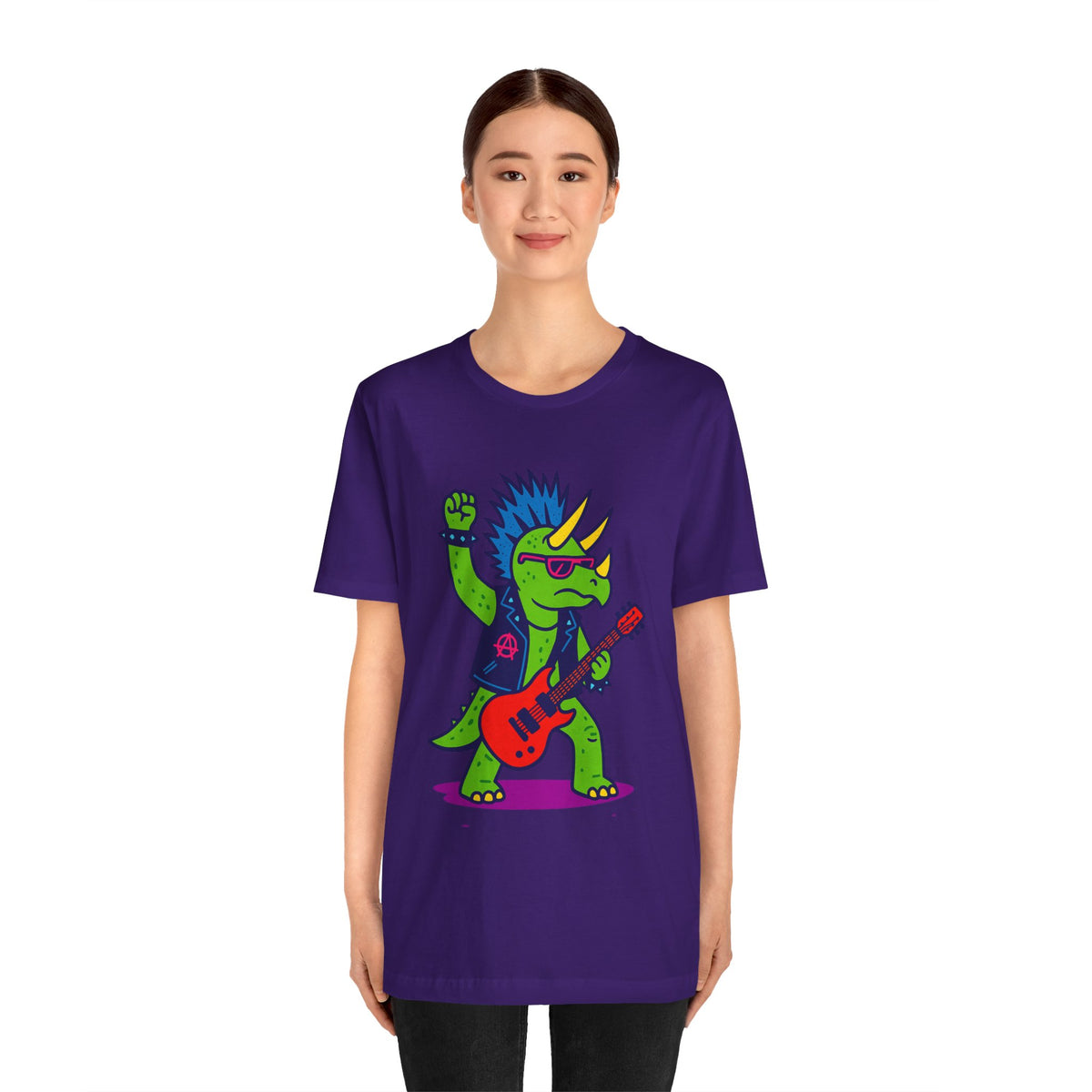 Purple crewneck graphic dinosaur t-shirt with triceratops playing guitar, worn by woman