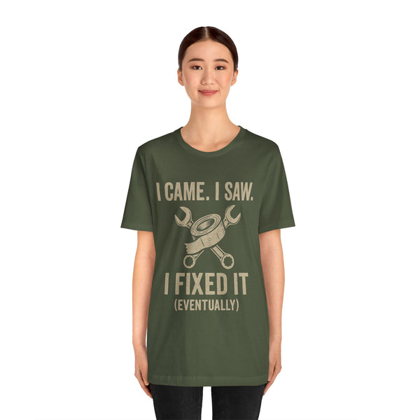 Fix-it humor T-shirt in dark green with centered repair text and crossed tools graphic