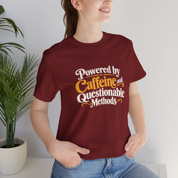 Maroon graphic T-shirt with "Powered by Caffeine and Questionable Methods" front print on model