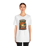 White crew-neck t-shirt with colorful pumpkin graphic on model