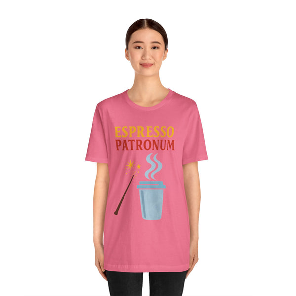 Pink crew-neck T-shirt worn by model, espresso-themed graphic with wand and cup