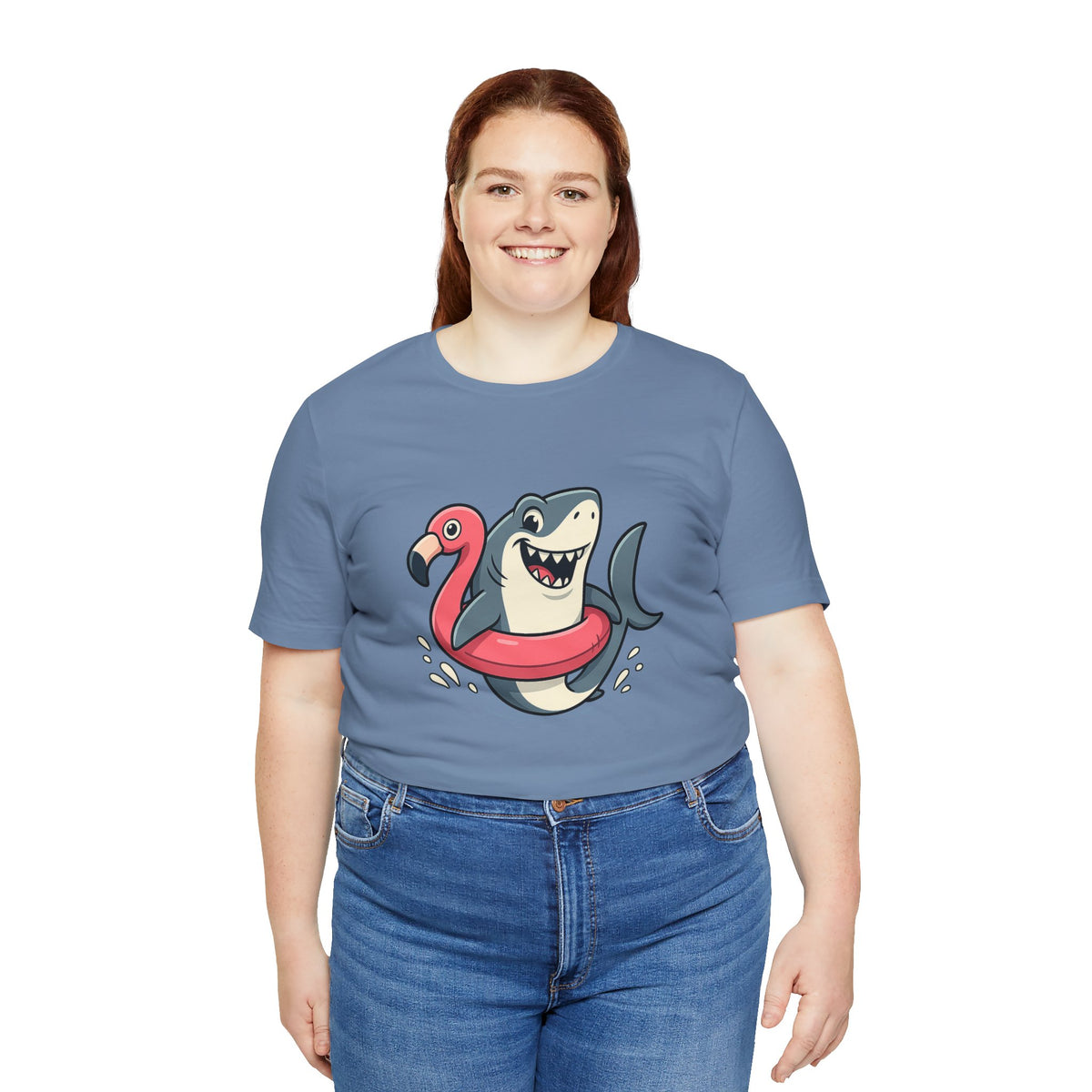 Blue crew-neck T-shirt with shark and flamingo graphic; worn with jeans